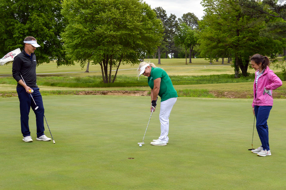 A chamber member putting on a golf course during the membership golf tournament