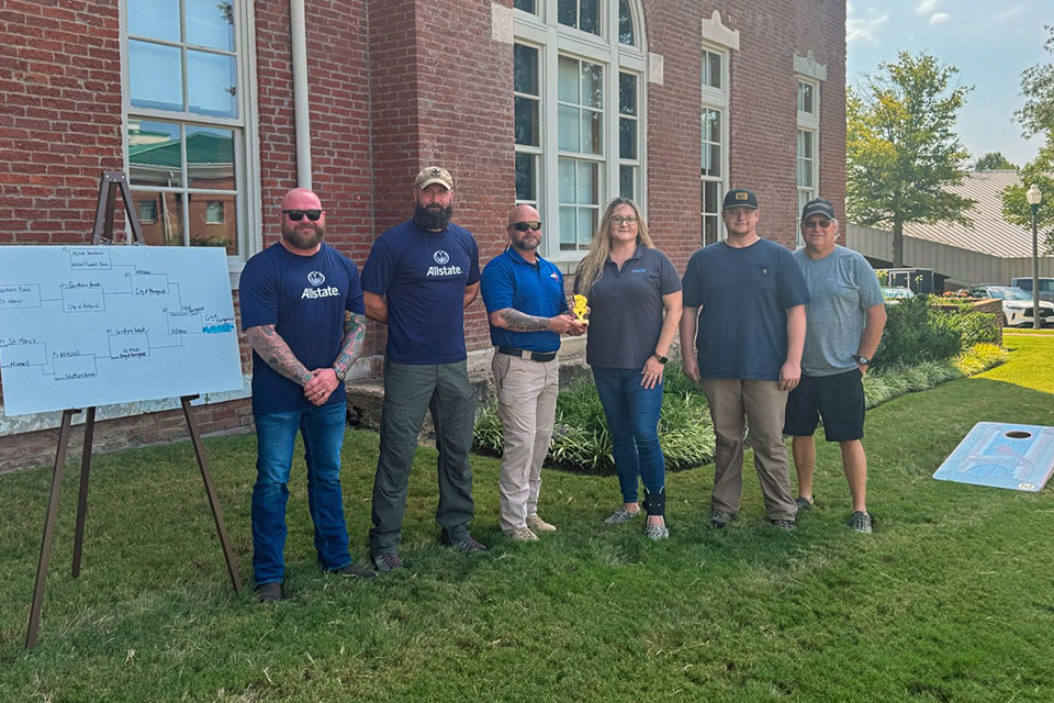 Members of the chamber playing cornhole outside of the chamber office
