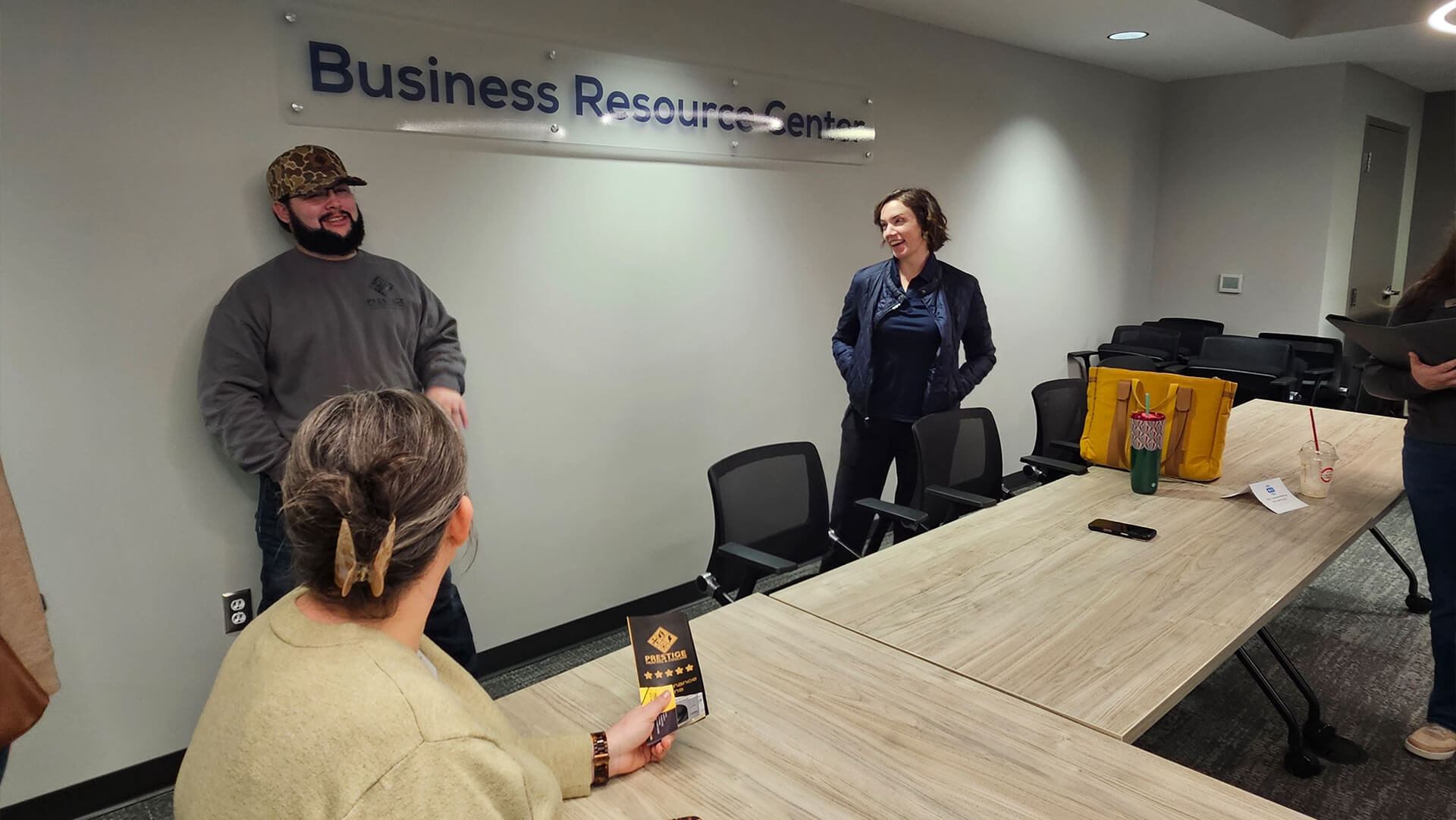 Business professionals networking and discussing referrals at a Paragould Regional Chamber of Commerce Business Resource Center meeting