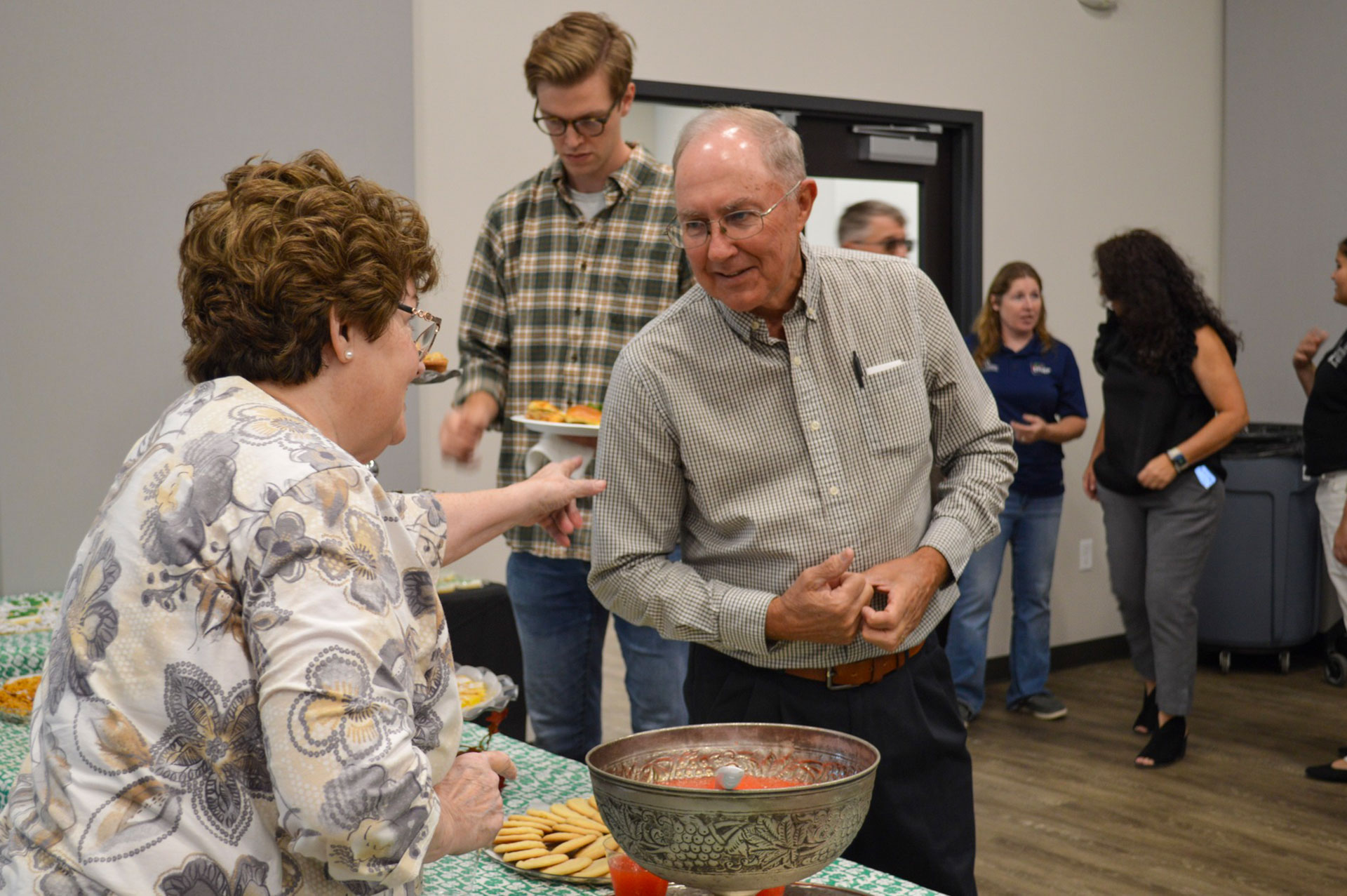 Event Guests talking during refreshments at the ribbon cutting!