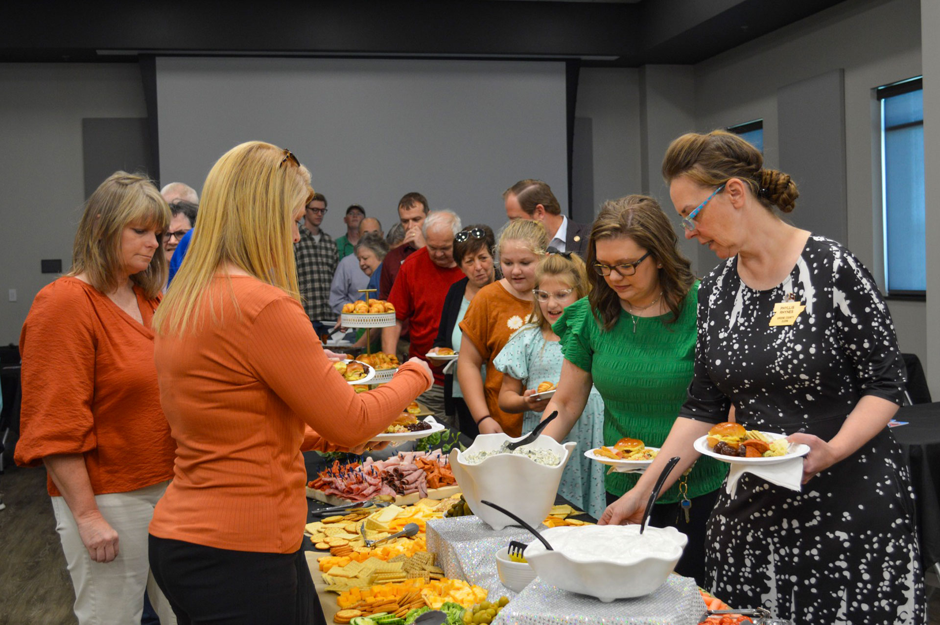Guests gathering for refreshments at the ribbon cutting!